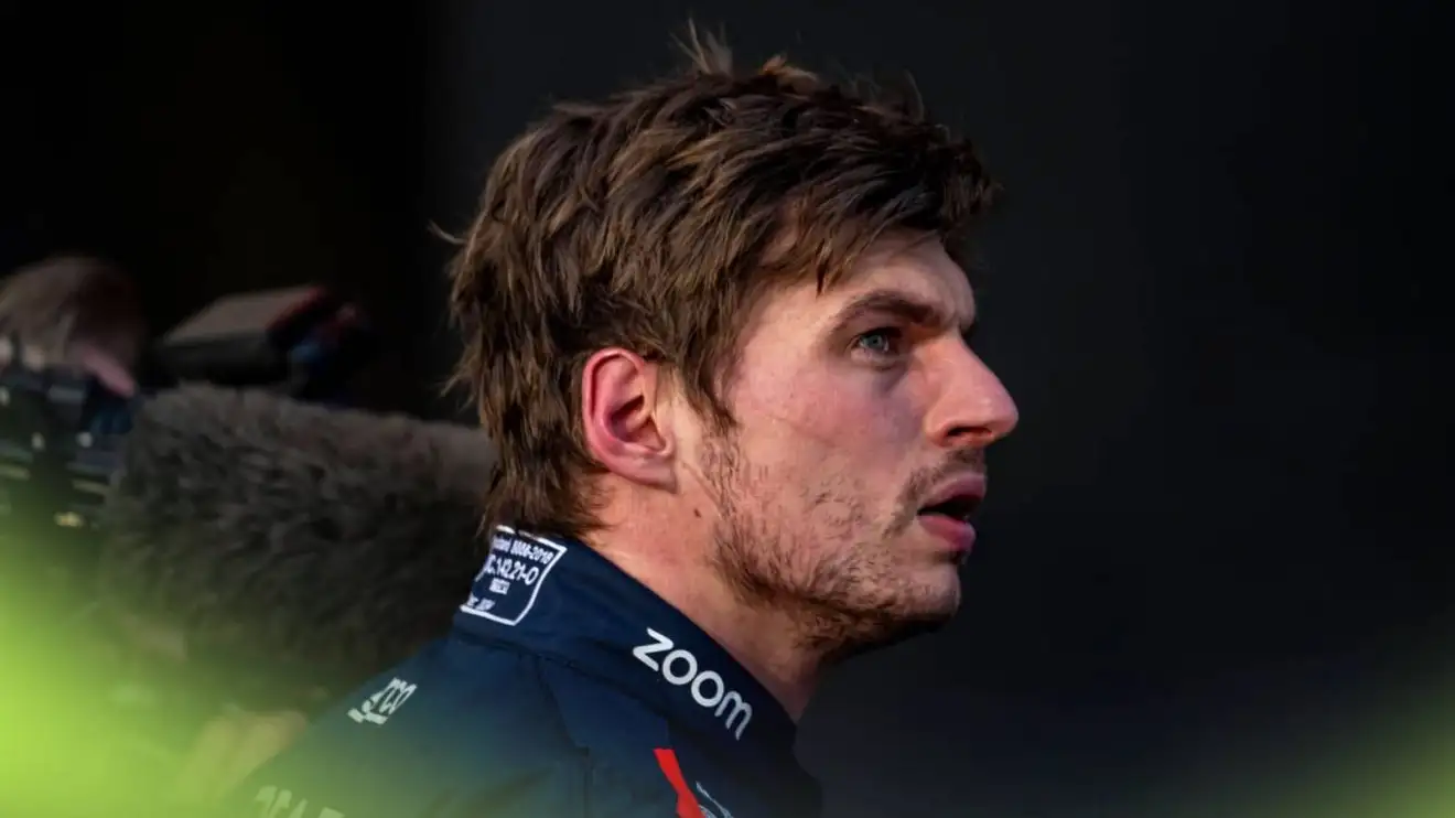 A side-profile shot of Max Verstappen looking annoyed