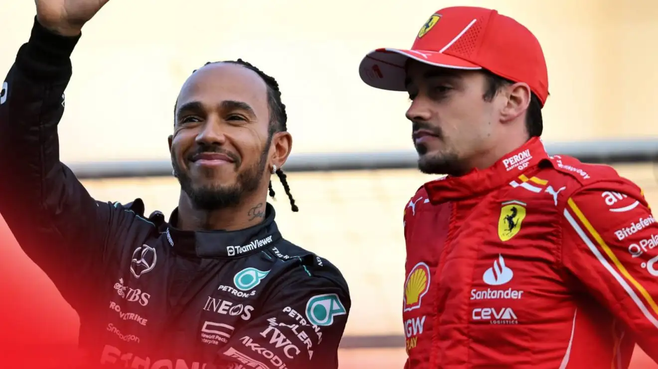 c-654 A smiling Lewis Hamilton waves to the crowd as Charles Leclerc looks on