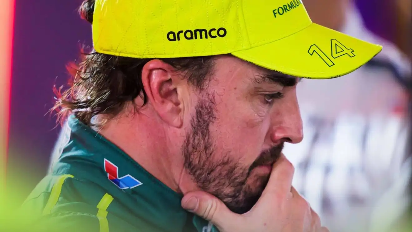 c-657 Fernando Alonso looks deep in thought with his hand pressed to his face