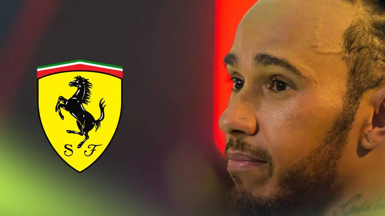 c-702 A close-up shot of Lewis Hamilton with a prominent Ferrari logo alongside him