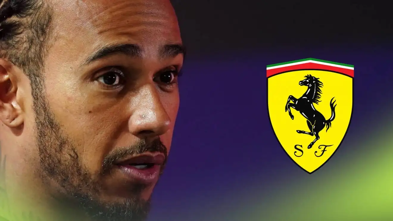 c-738 Lewis Hamilton looks alarmed with a prominent Ferrari logo alongside him