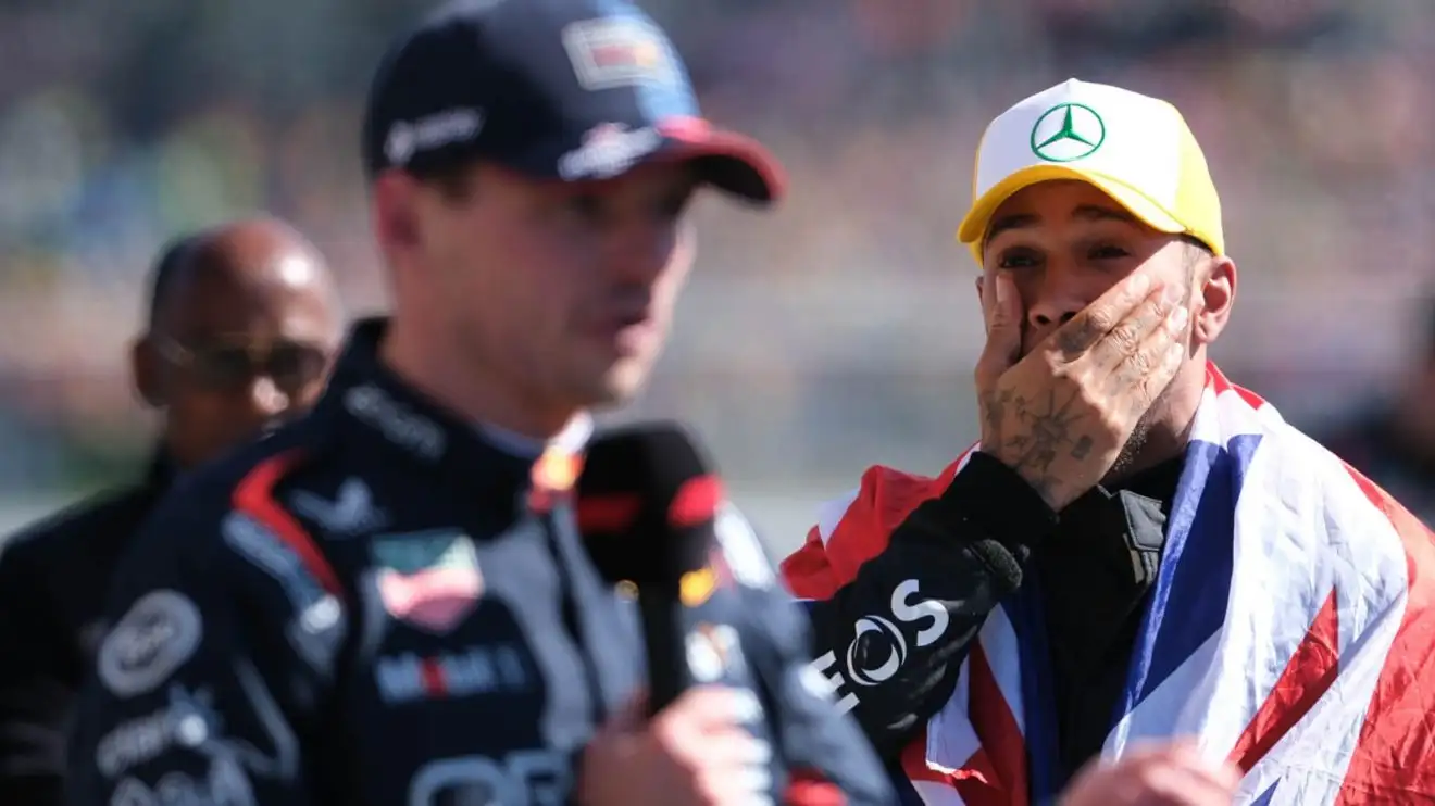 c-744 Lewis Hamilton stands behind Max Verstappen as he gives his post-race interview
