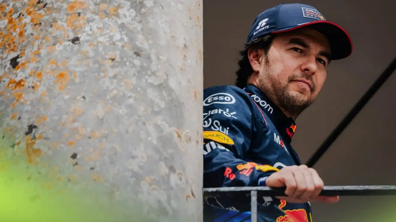 c-765 Sergio Perez rests his hand on the barrier at Goodwood with a pillar alongside him