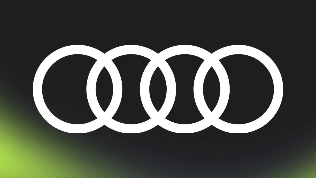 c-768 A white Audi logo against a black background with PlanetF1.com's lime-green mist at the bottom