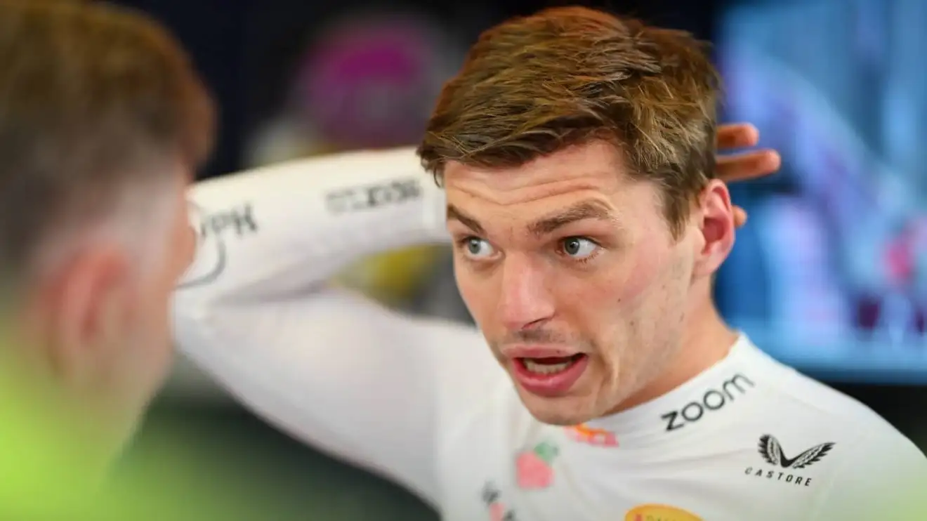 c-780 Max Verstappen in animated conversation in the Red Bull garage