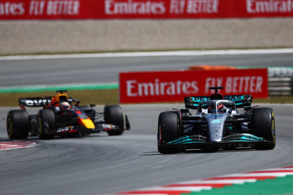 George Russell of Great Britain driving the (63) Mercedes AMG Petronas F1 Team Mercedes W13 and Max Verstappen of the Netherlands driving the (1) O...