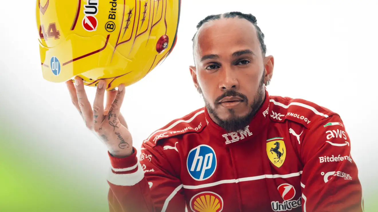 c-391 Lewis Hamilton poses as he balances his yellow Ferrari helmet in one hand