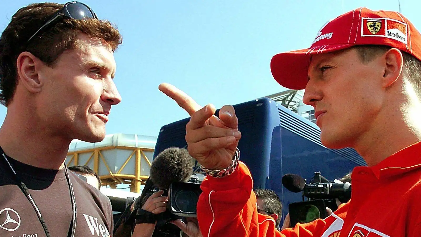 c-397 David Coulthard and Michael Schumacher in discussion at the 2004 San Marino Grand Prix.