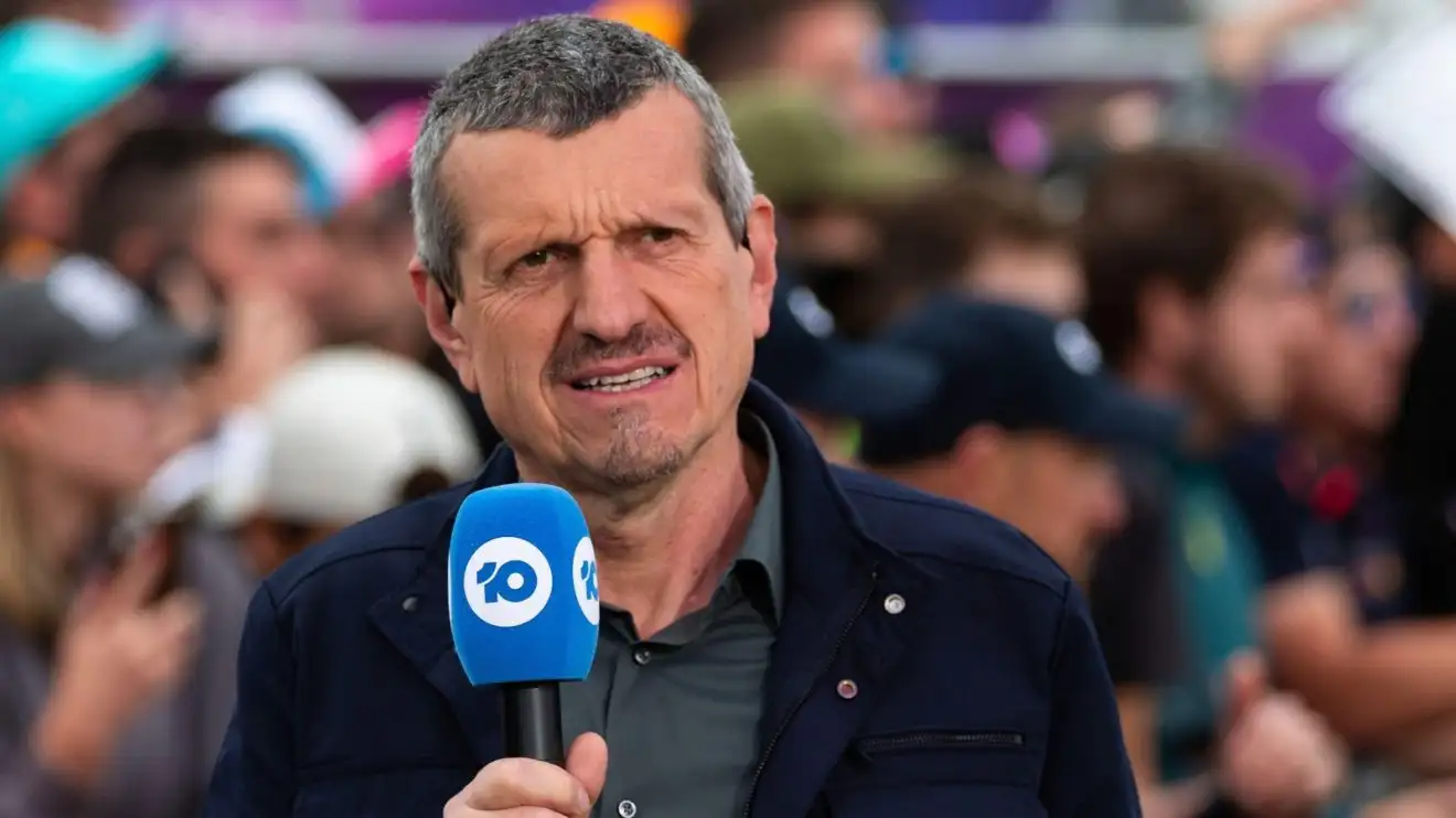 c-436 Guenther Steiner holding a microphone