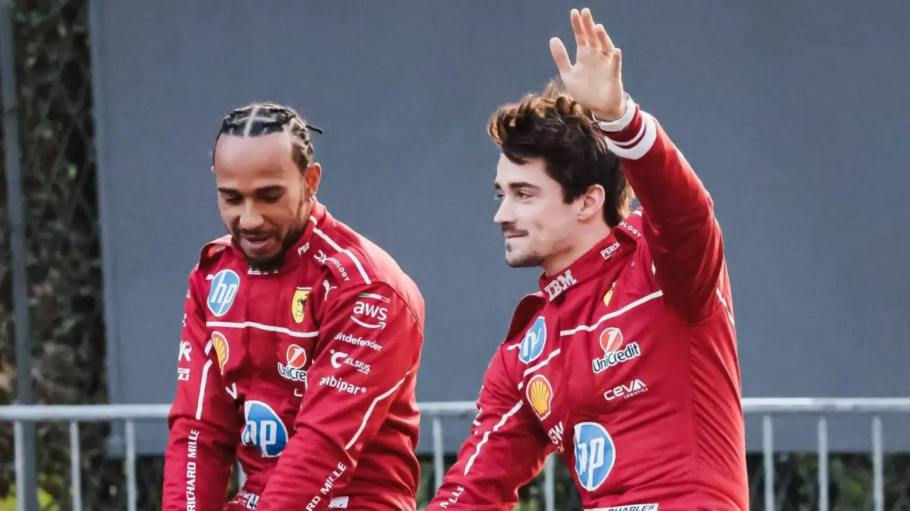 c-439 Charles Leclerc waves alongside Ferrari team-mate Lewis Hamilton at a Milan street event