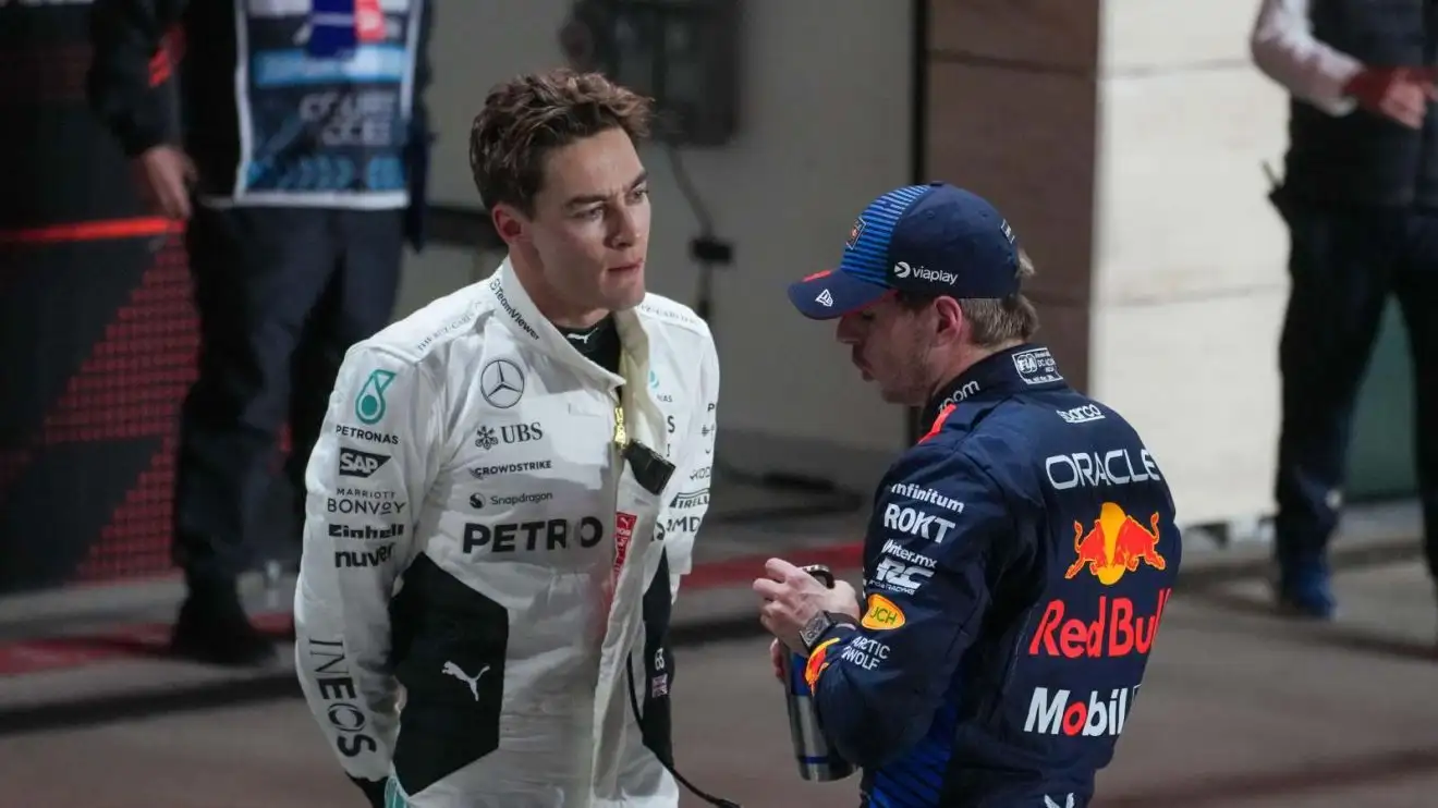c-445 George Russell and Max Verstappen talk in Qatar.