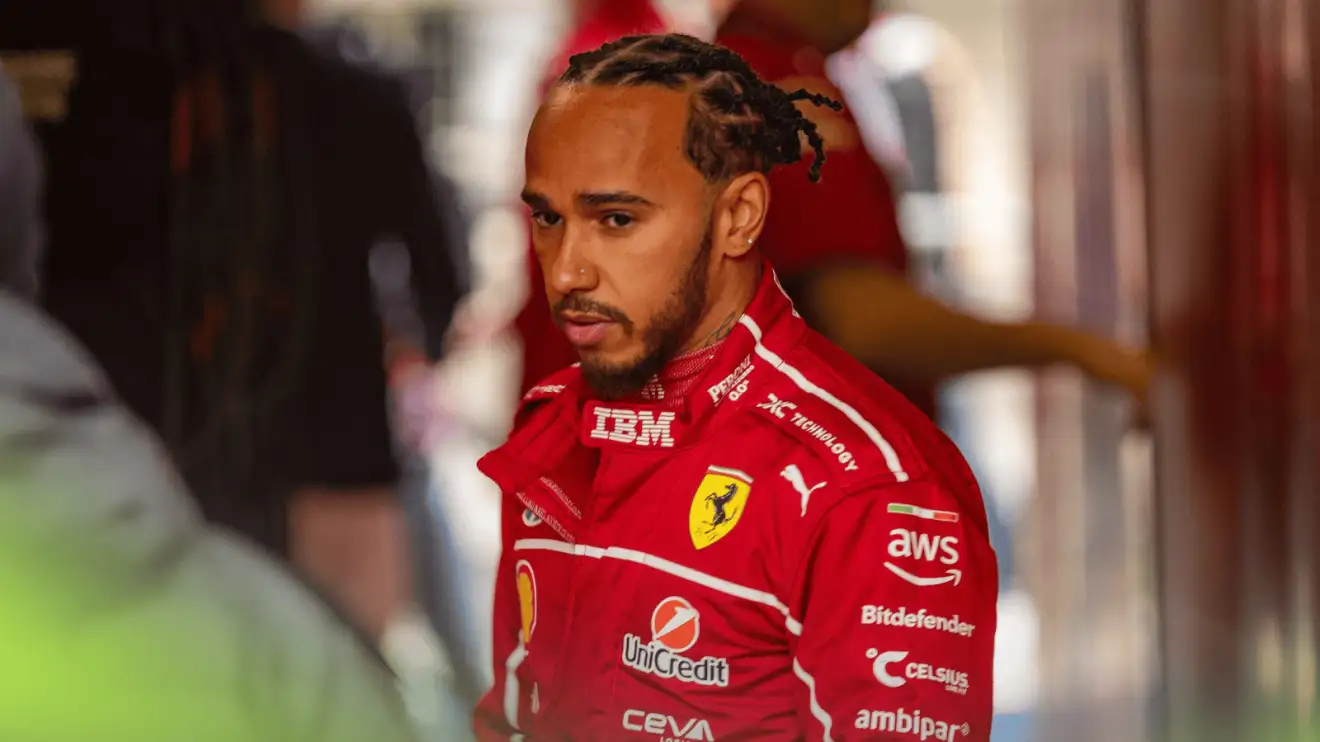 c-448 Lewis Hamilton stood wearing Ferrari overalls