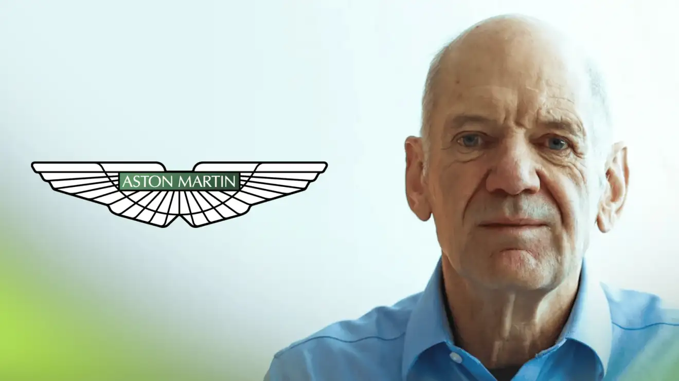 c-1194 A studio shot of Adrian Newey with a prominent Aston Martin logo alongside him