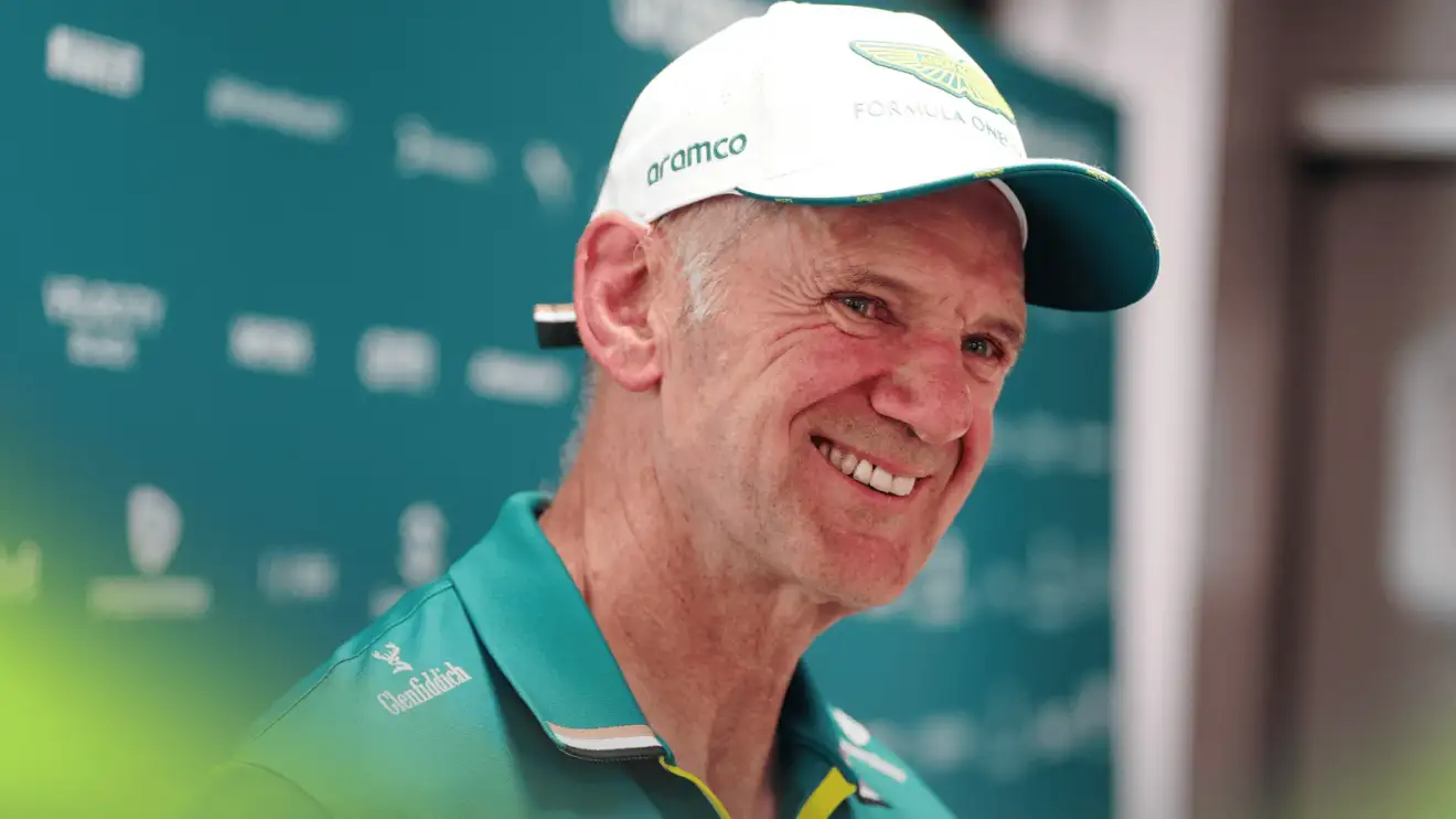 c-1347 Adrian Newey smiles while wearing Aston Martin team kit