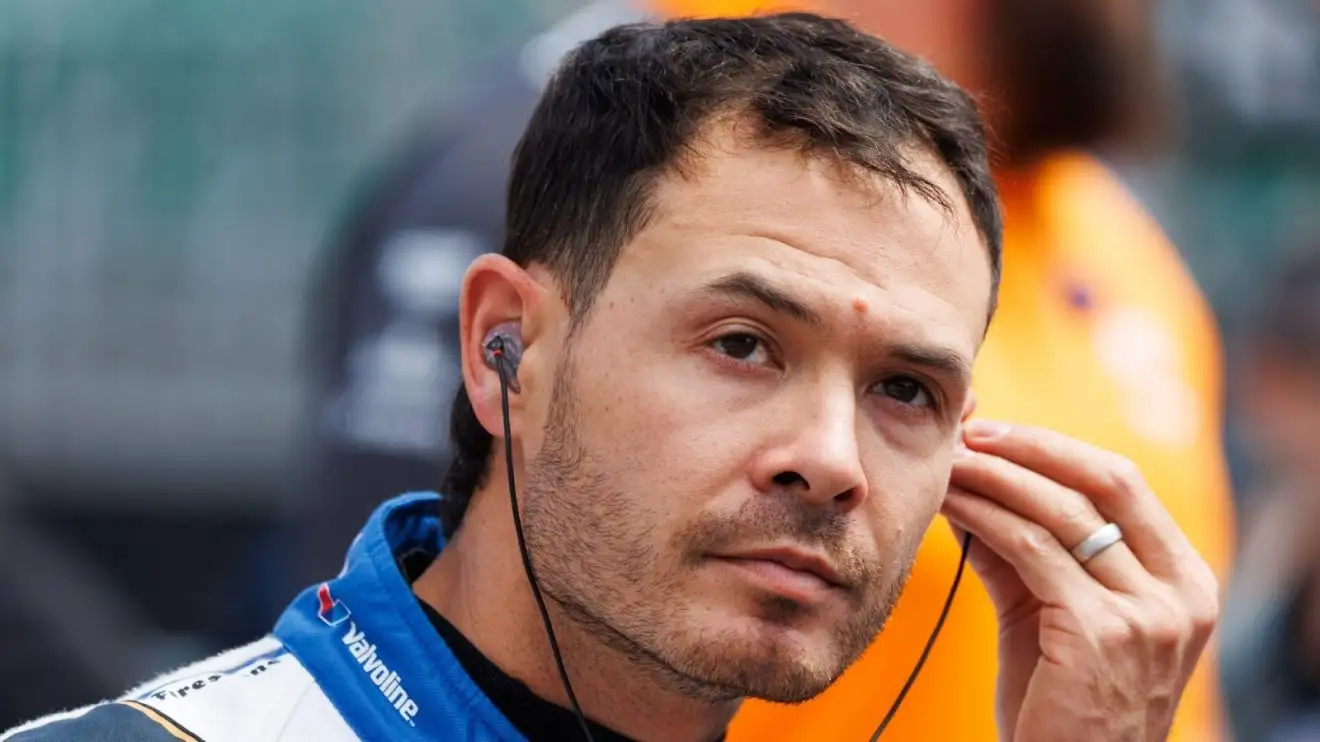 c-1419 Kyle Larson in team overalls prepares to climb into his race car.