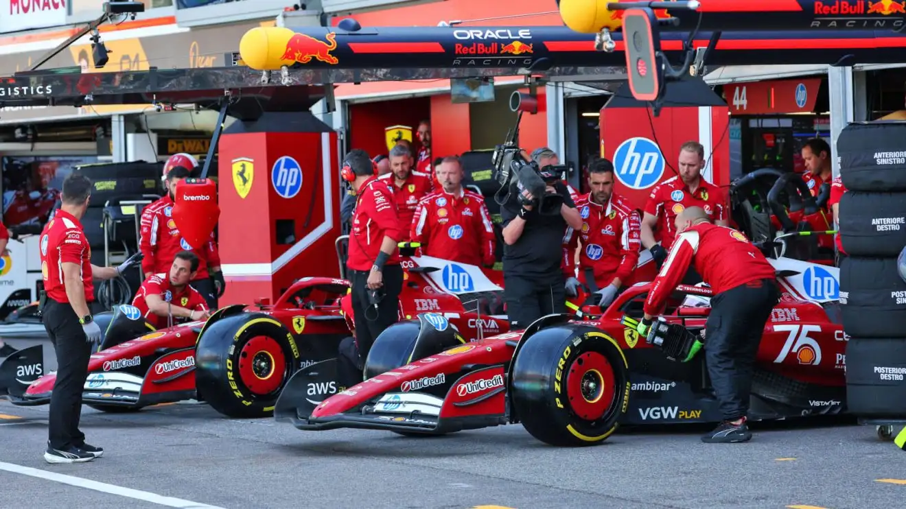c-1437 Charles Leclerc and Lewis Hamilton leave the garages