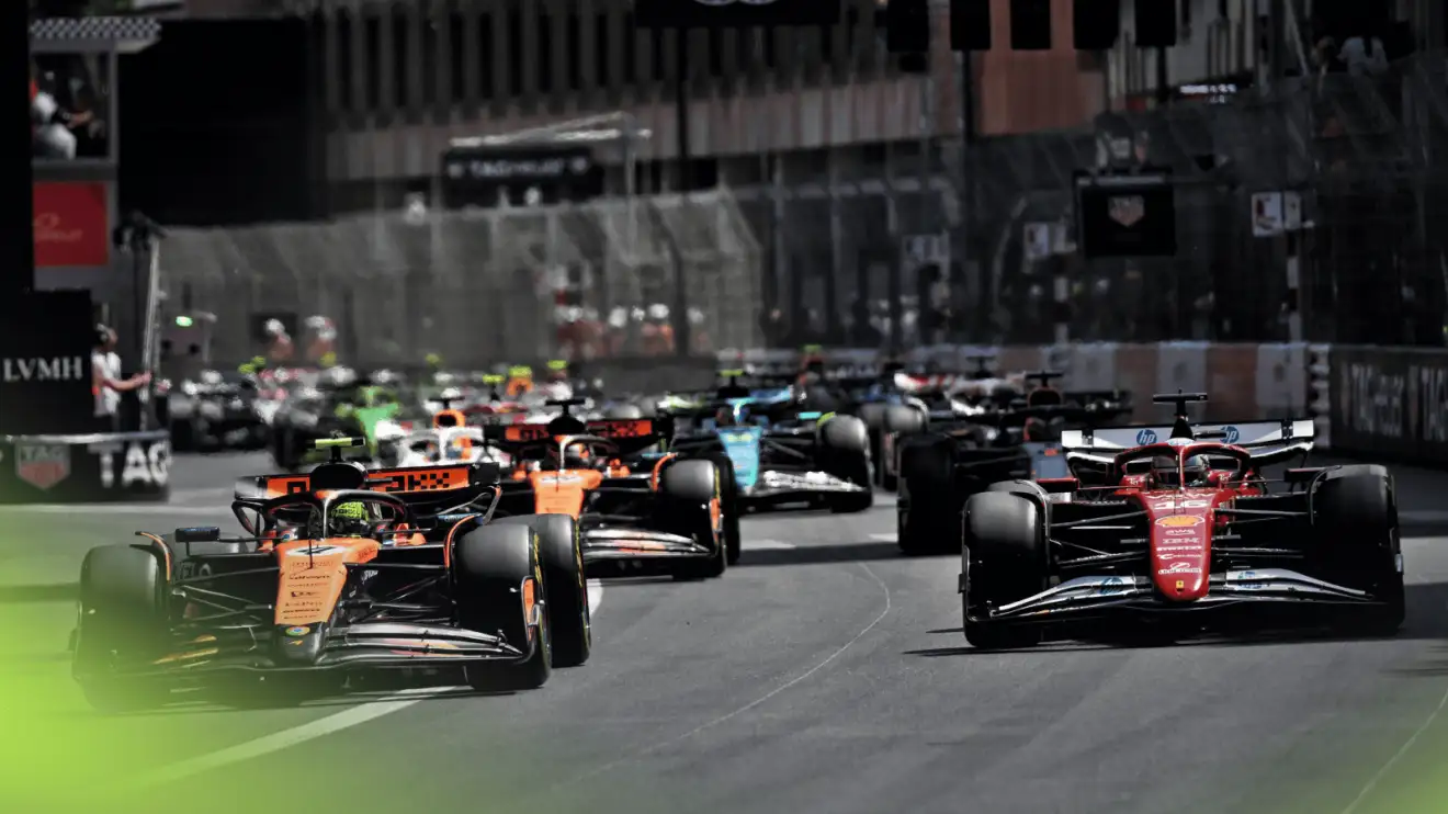 c-1502 Lando Norris leads the field off the line at the start in Monaco