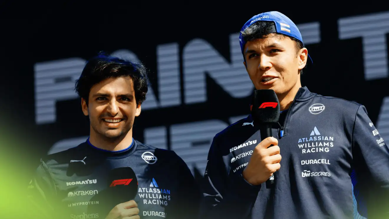 c-1565 Carlos Sainz and Alex Albon holding microphones on stage at an event