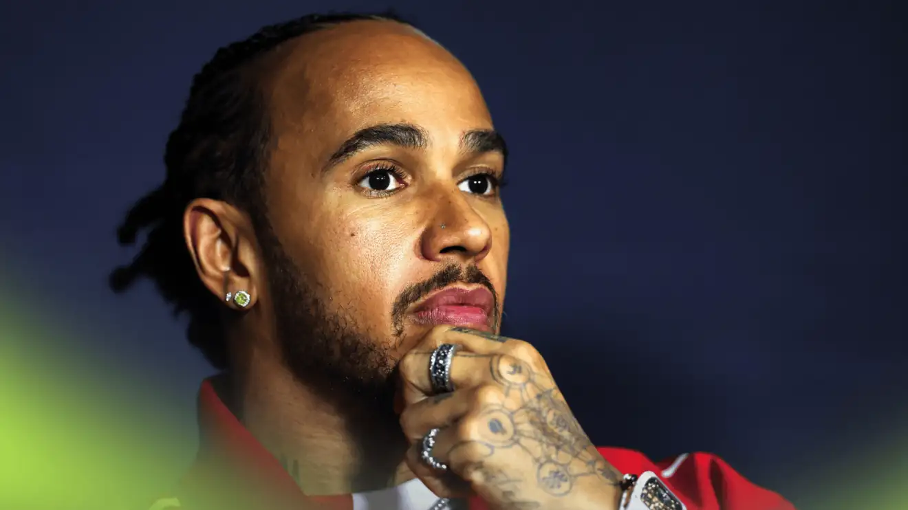 c-1634 Lewis Hamilton holds his hand to his chin during a press conference in Australia