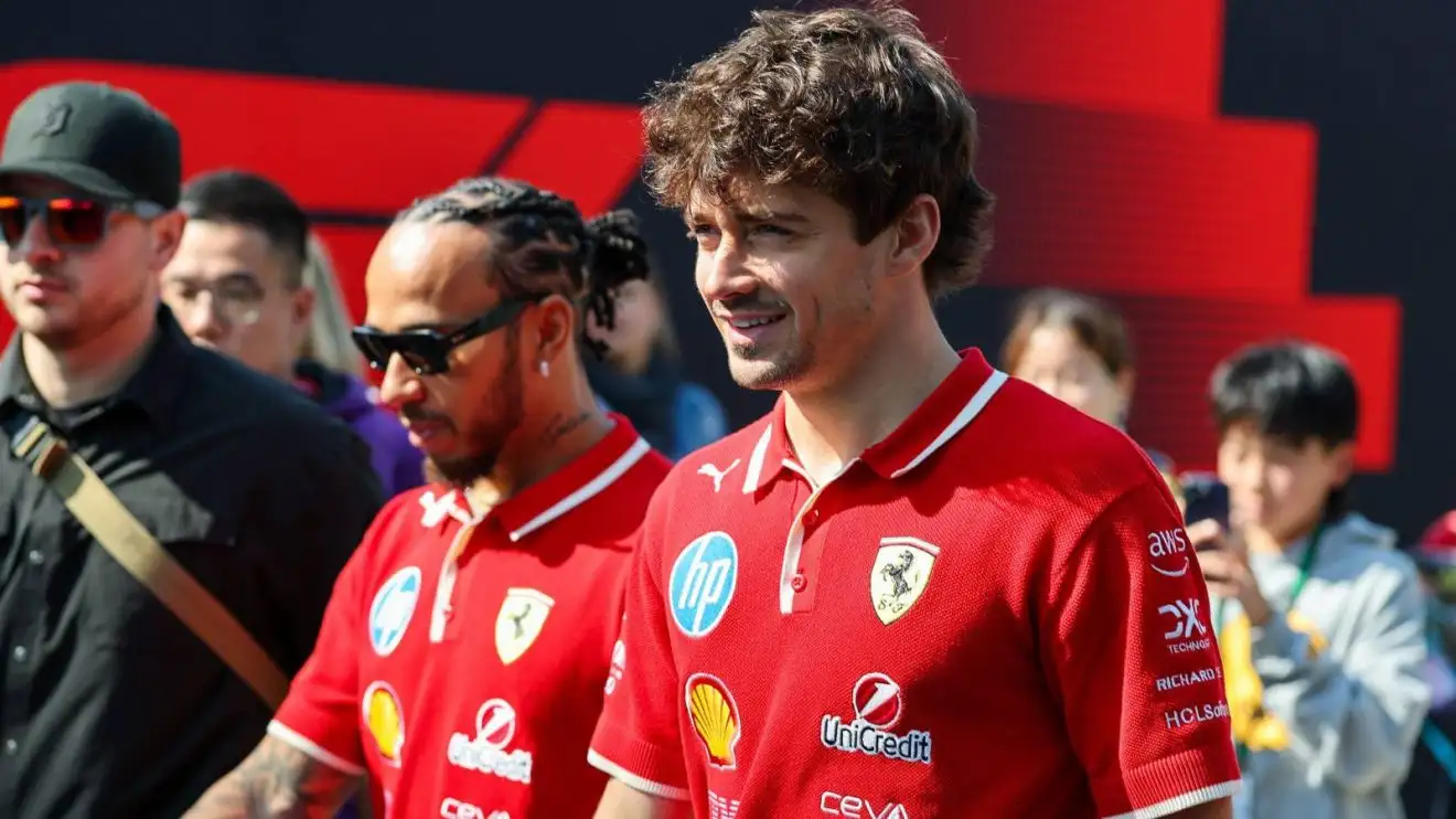 c-294 Ferrari team-mates Charles Leclerc and Lewis Hamilton walk through the paddock at the 2025 Chinese Grand Prix