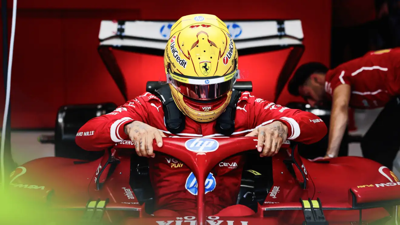 c-737 Lewis Hamilton holds on to the halo as he lowers himself into the SF-25 in the Ferrari garage
