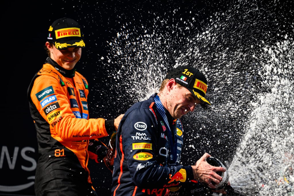 gettyimages-2215474738-1024x683-1 McLaren driver Oscar Piastri and Max Verstappen of Red Bull celebrate on the Imola podium after the 2025 F1 Emilia Romagna Grand Prix