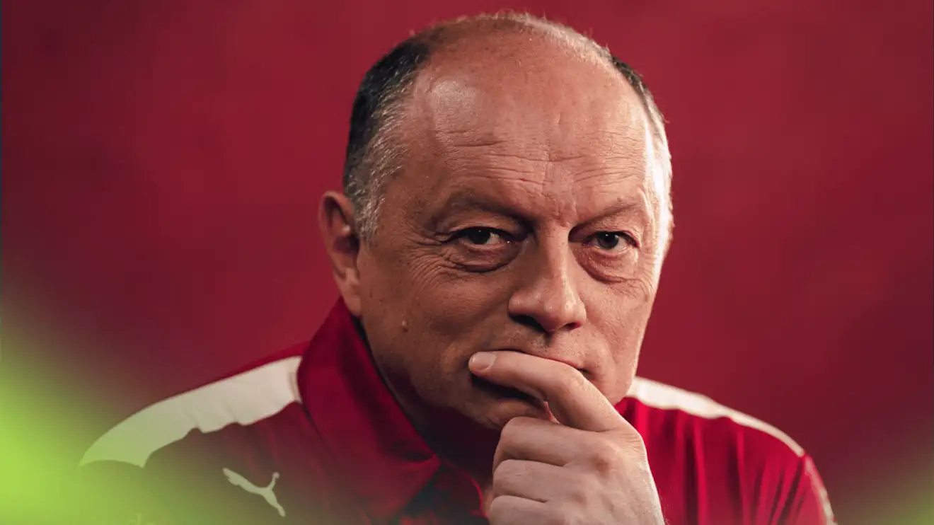 c-1006 A studio shot of Fred Vasseur holding his hand to his mouth against a red background
