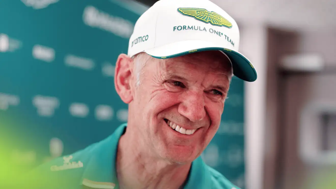 c-1015 Adrian Newey smiles broadly while wearing Aston Martin team kit