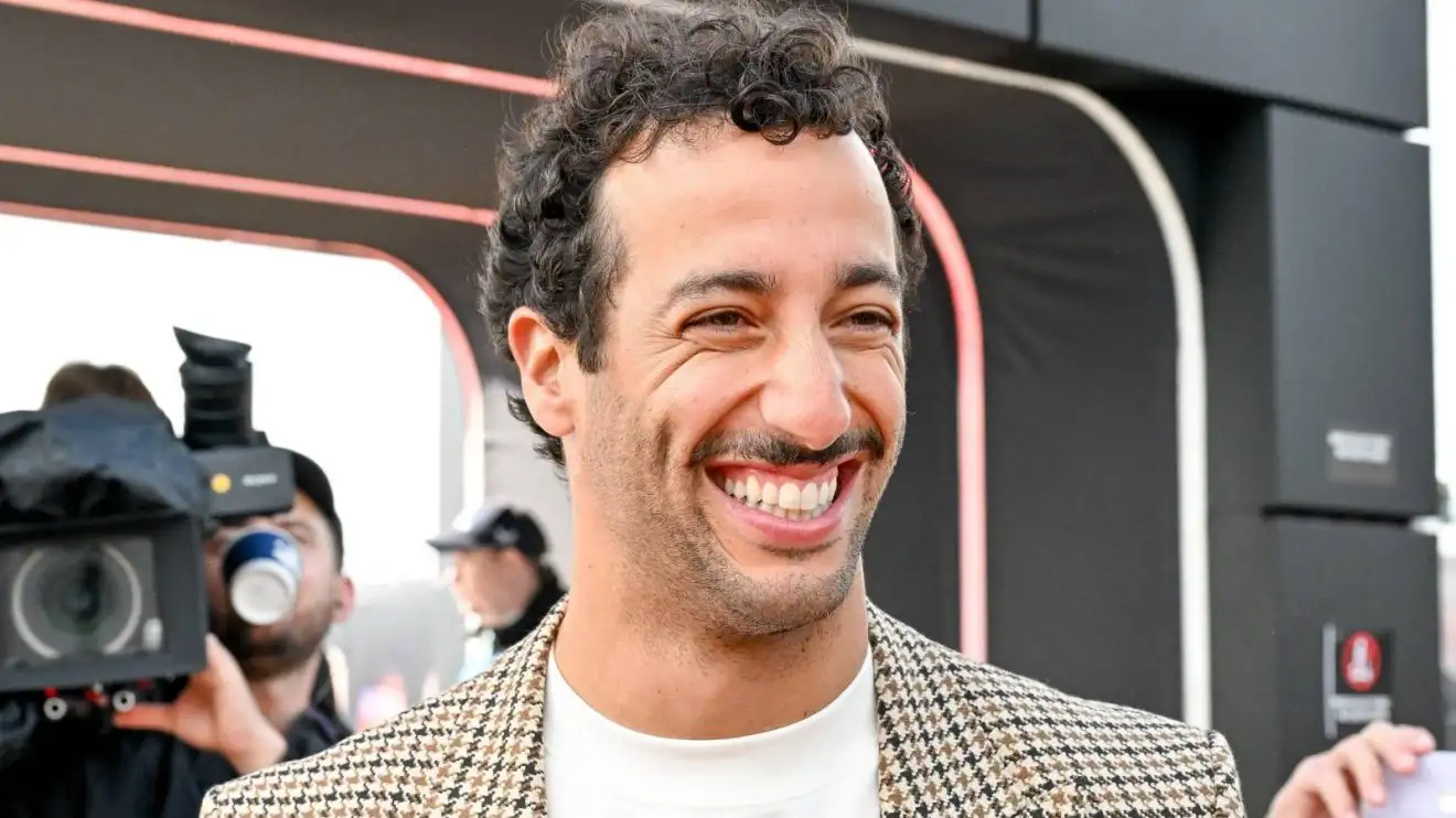 c-1060 A smiling Daniel Ricciardo enters the Formula 1 paddock at the 2024 British Grand Prix.