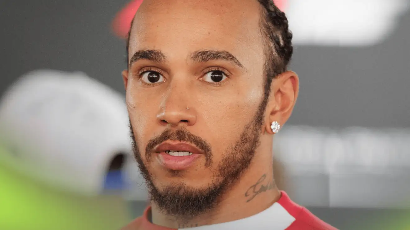 c-162 Lewis Hamilton eyes the camera while facing the media