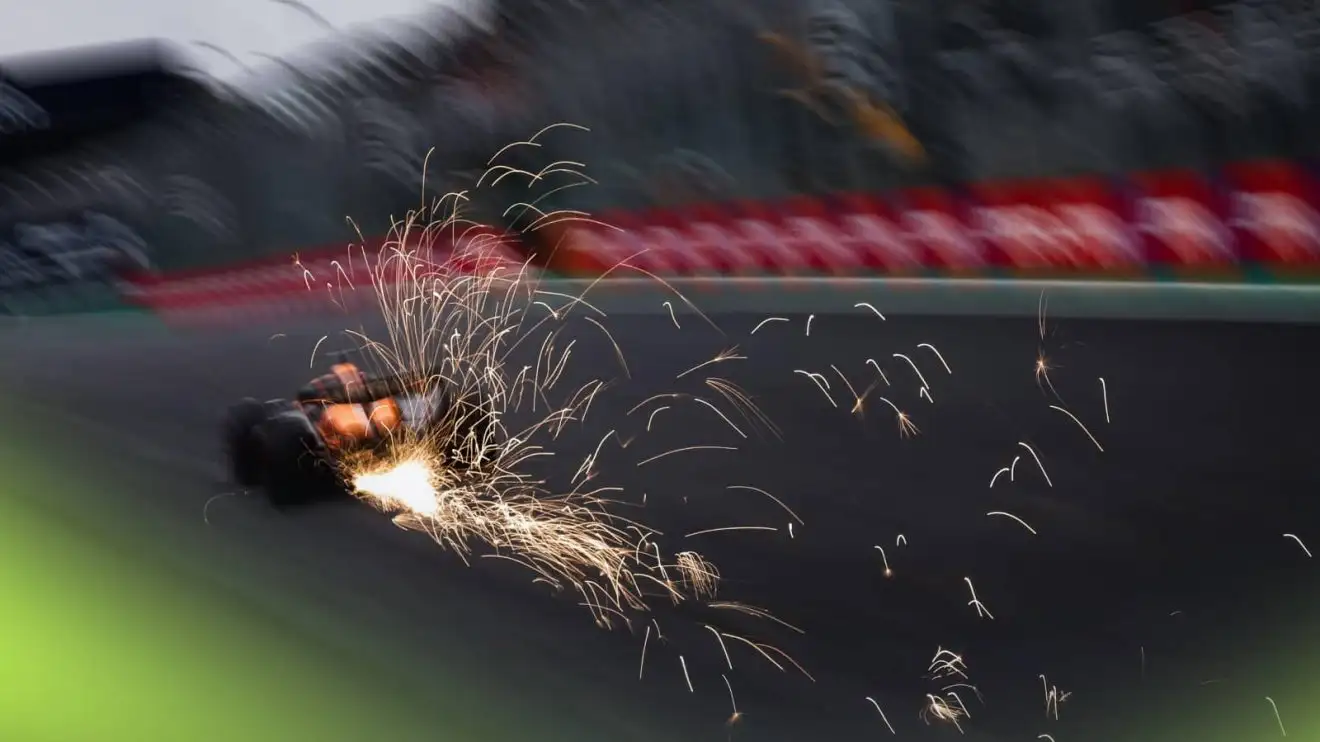 c-186 A dramatic rear-facing shot of Oscar Piastri's McLaren kicking up a shower of sparks on the main straight in Brazil