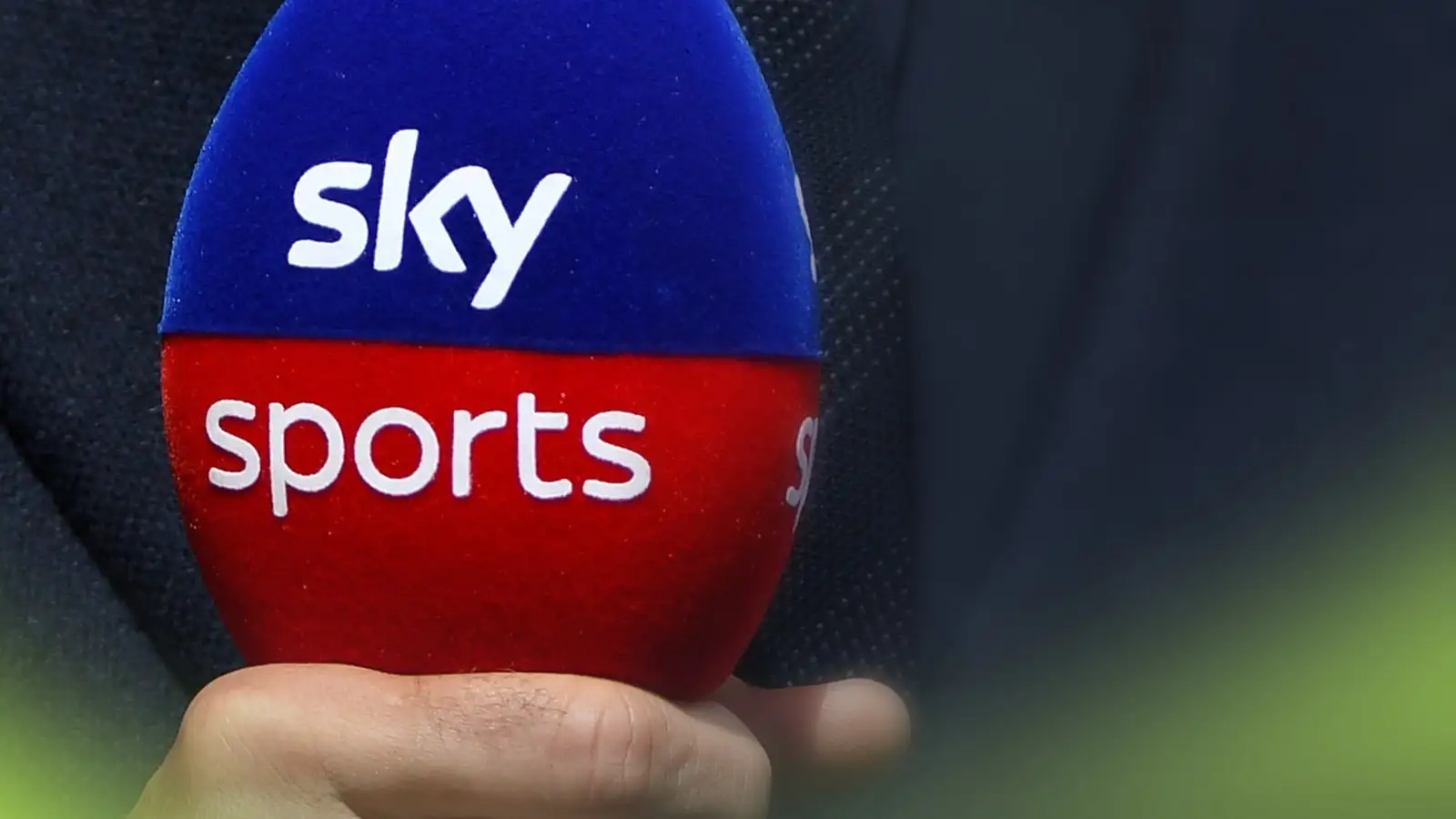 c-299 A Sky Sports microphone in the grip of a presenter's hand