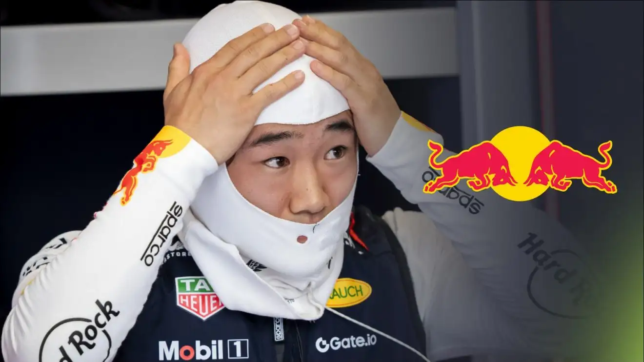 c-308 Yuki Tsunoda with his hands on his head in the Red Bull garage at the 2025 Spanish Grand Prix, with a Red Bull logo to his right