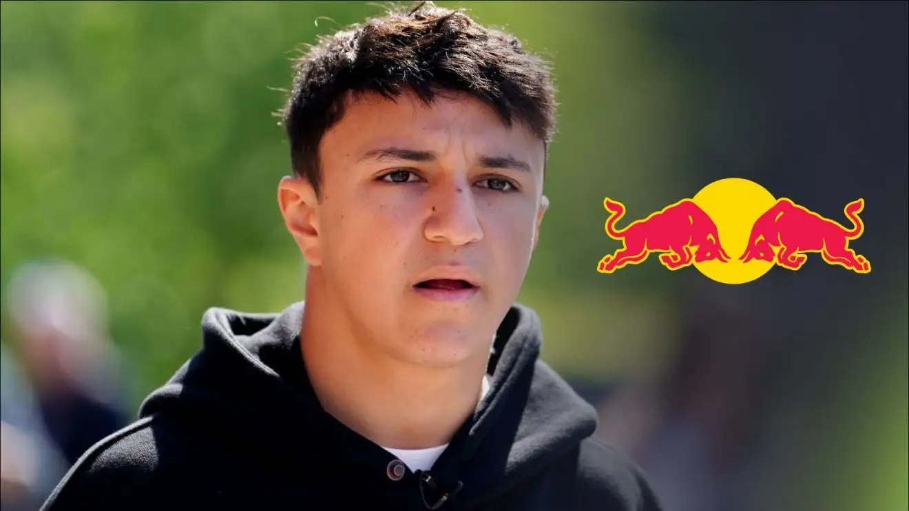 c-335 Isack Hadjar pictured at the 2025 Emilia Romagna Grand Prix, with a Red Bull logo to his right