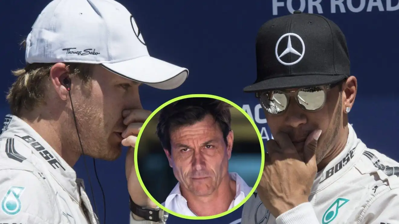 c-341 Lewis Hamilton and Nico Rosberg, Mercedes, with a hand to their mouth, and Mercedes team principal Toto Wolff in a central circle