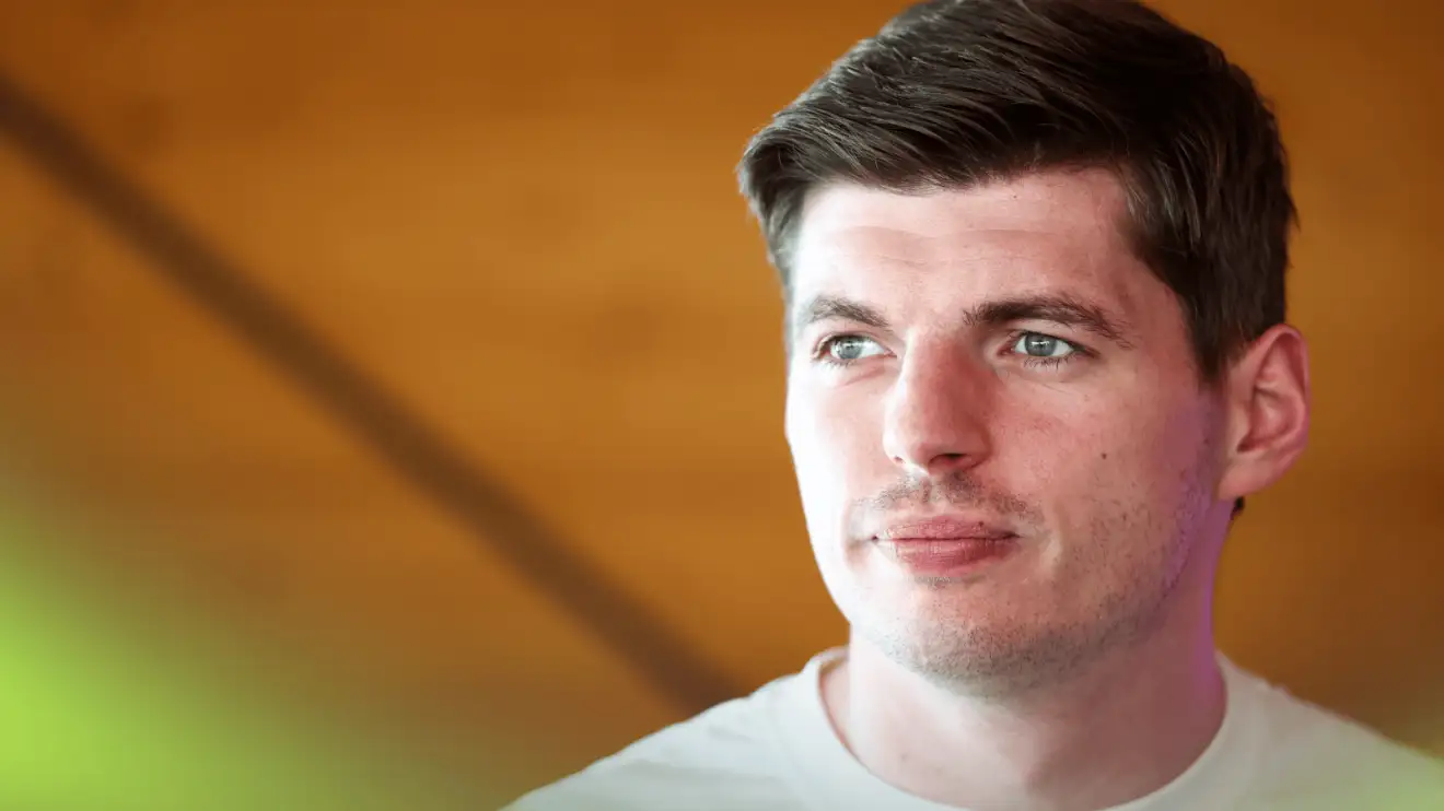 c-414 Max Verstappen looking into the distance while wearing a plain-white t-shirt