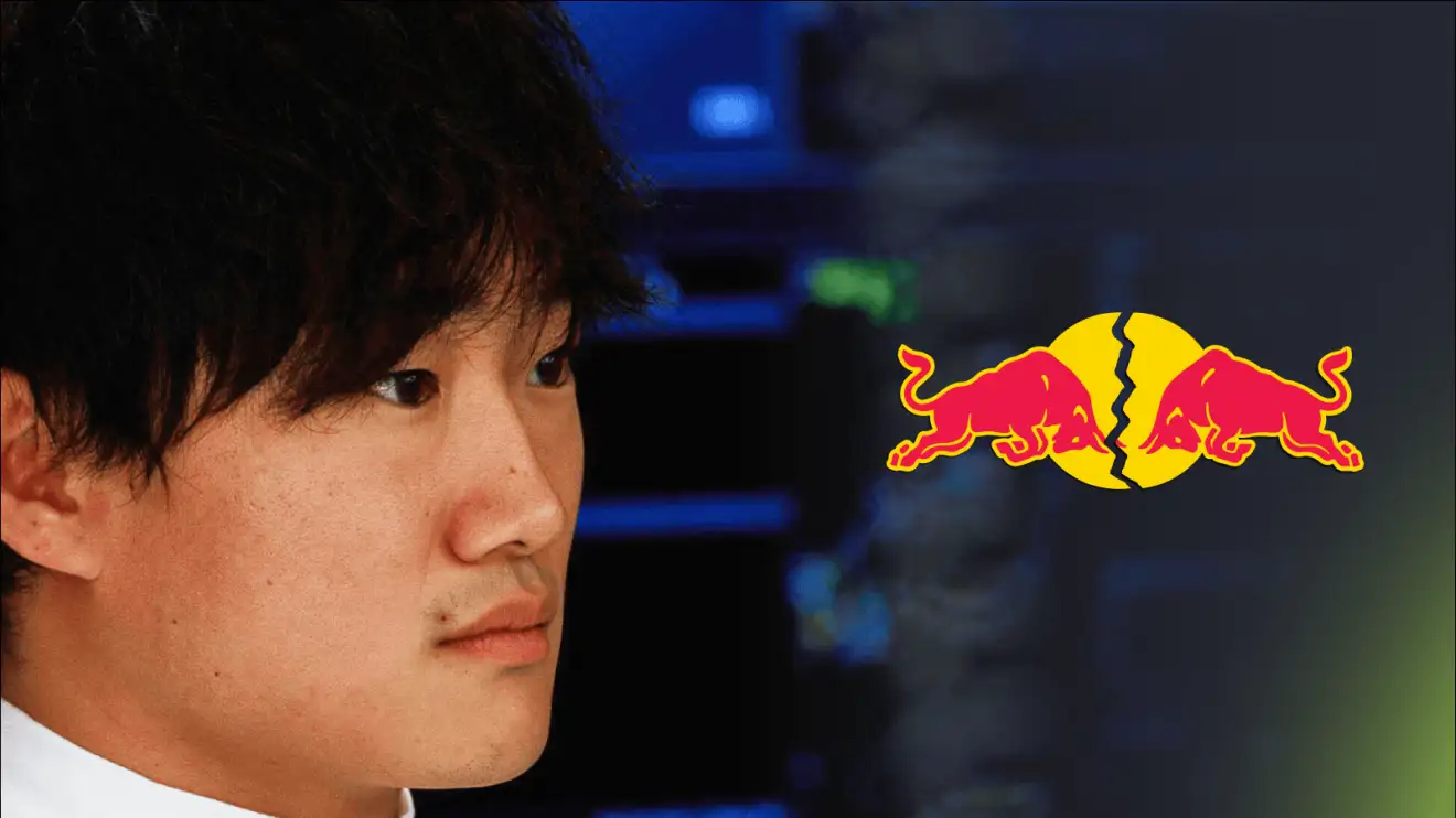 c-554 A close-up shot of Yuki Tsunoda with a cracked Red Bull logo alongside him