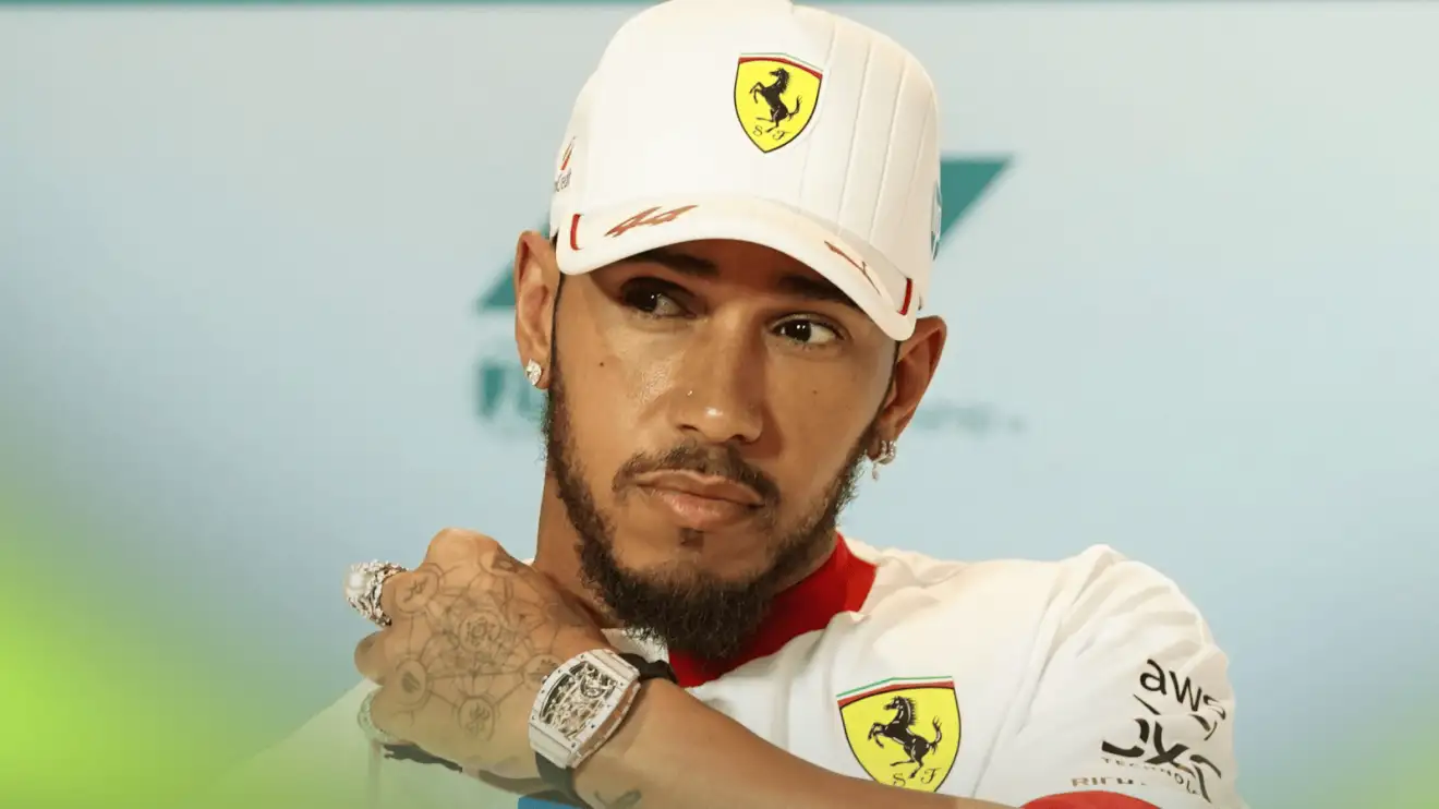 c-566 Lewis Hamilton places his hand on his shoulder in a press conference