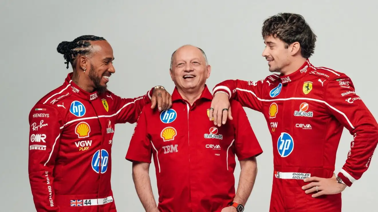c-632 Lewis Hamilton, Fred Vasseur, Charles Leclerc smile as they pose in a playful image for Ferrari