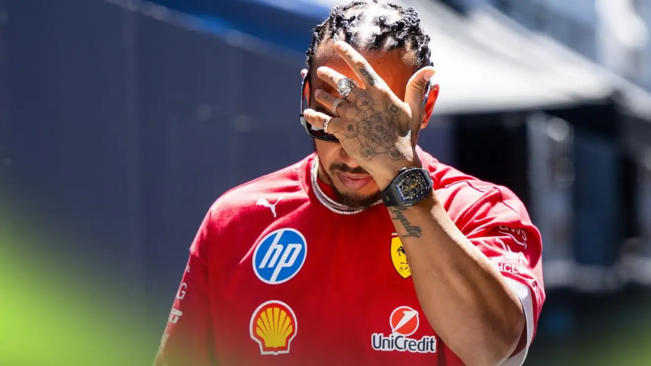 c-635 Ferrari driver Lewis Hamilton puts his hand to his head at the 2025 Spanish Grand Prix