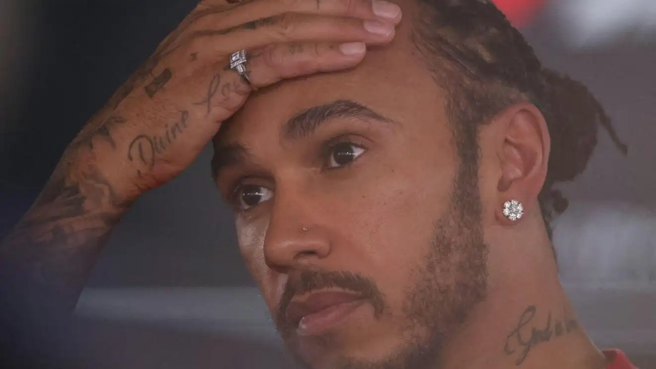 c-67 Lewis Hamilton has his hand on his head in the Spanish GP paddock.