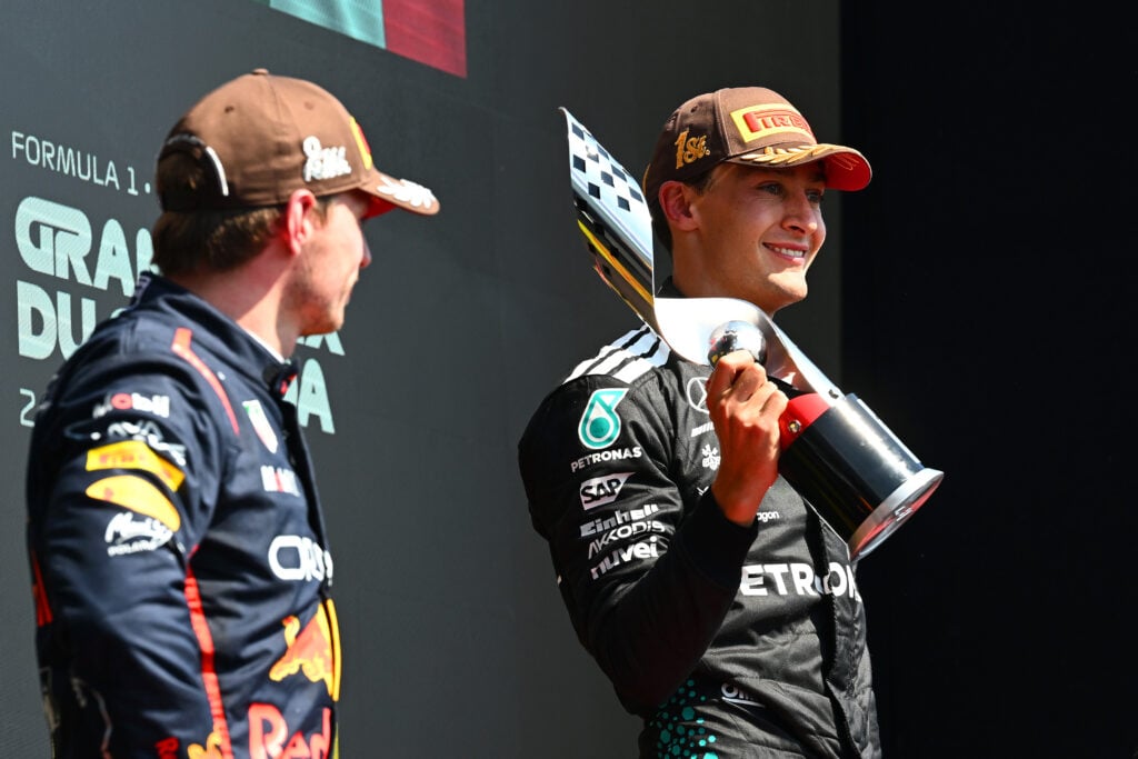 gettyimages-2220303601-1024x683-1 Red Bull driver Max Verstappen looks on as George Russell of Mercedes celebrates winning the 2025 F1 Canadian Grand Prix